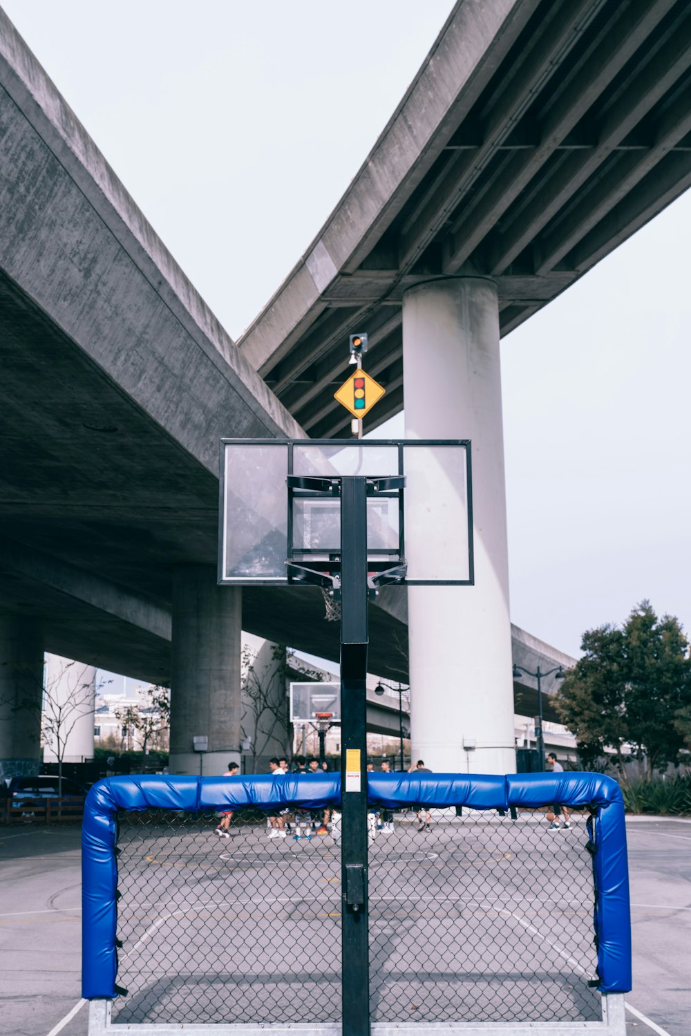 photo of soccer goalie below basketball system