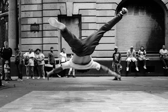 jumping man in grayscale photography