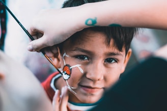 boy drawn Pokeball on his face