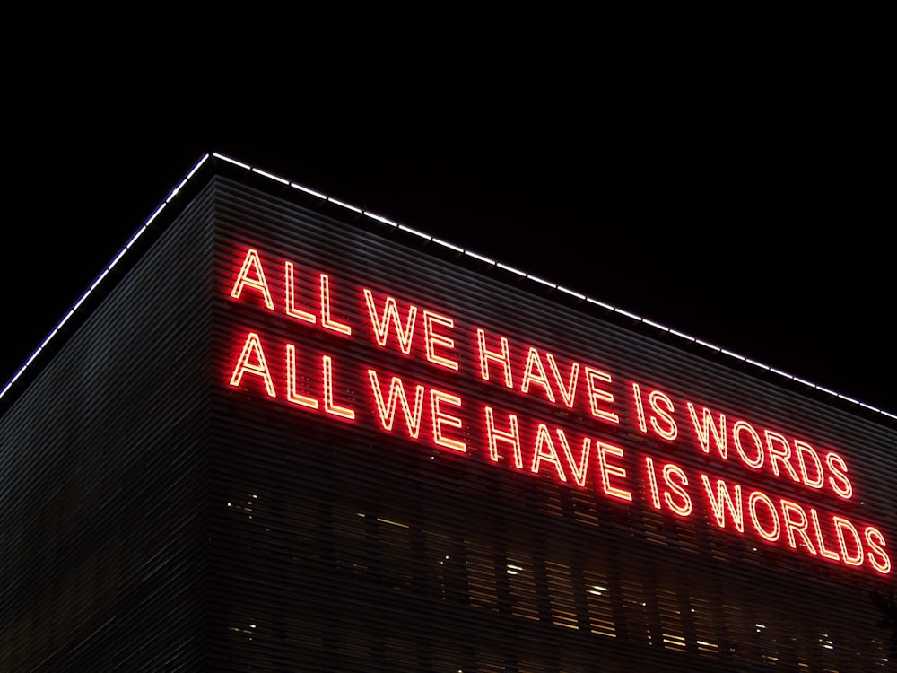 All We Have Is Words All We Have Is Worlds lighted signage at night