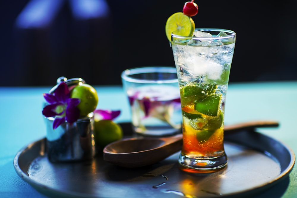 clear glass tumbler on black tray