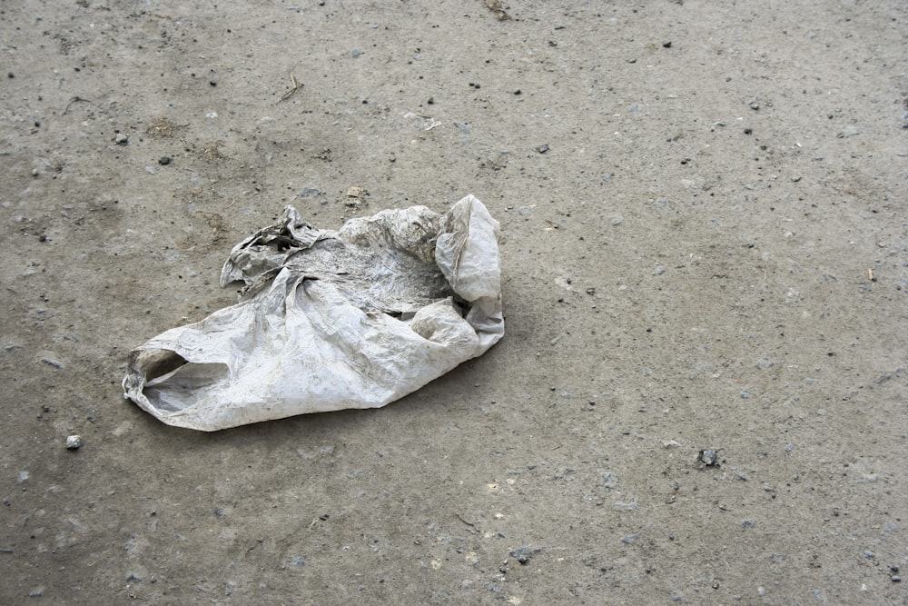 white plastic bag on gray surface