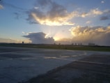 An outdoor runway set against a city skyline at sunset.