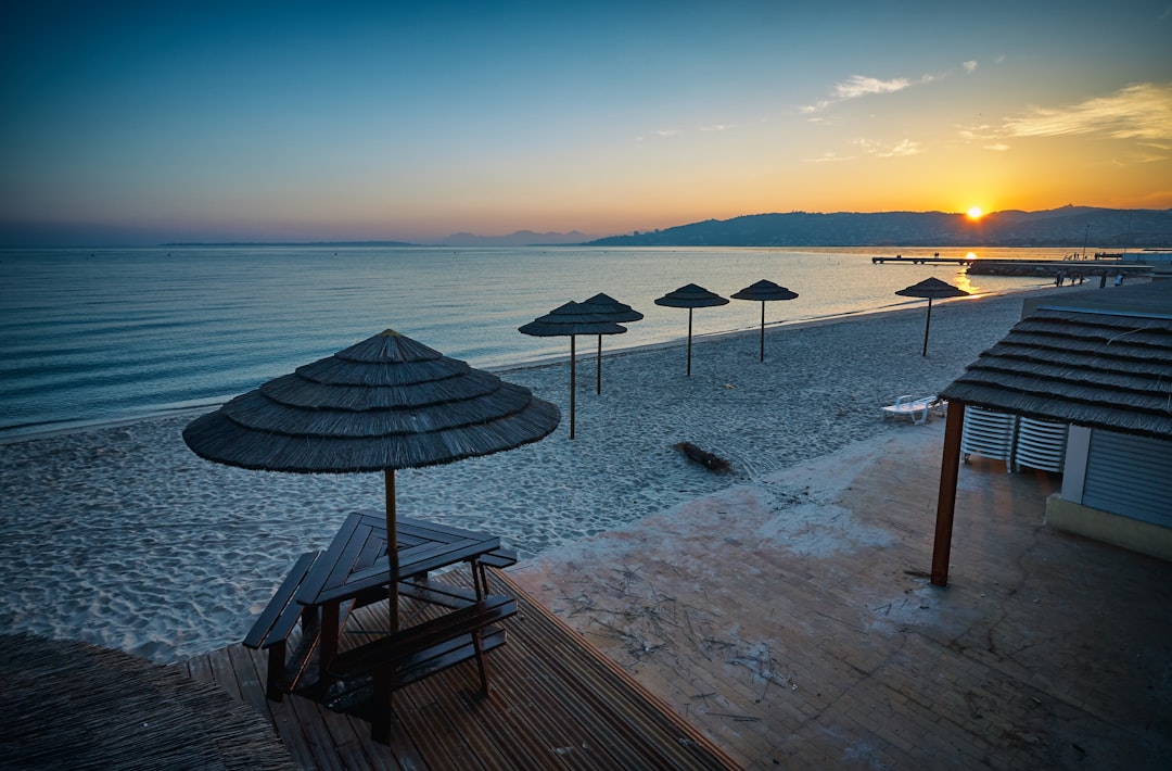 parasols on shore near sea at golden hour, Abandoned Beach
