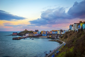multicolored buildings near cove under cloudy sky