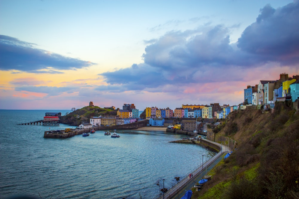 multicolored buildings near cove under cloudy sky