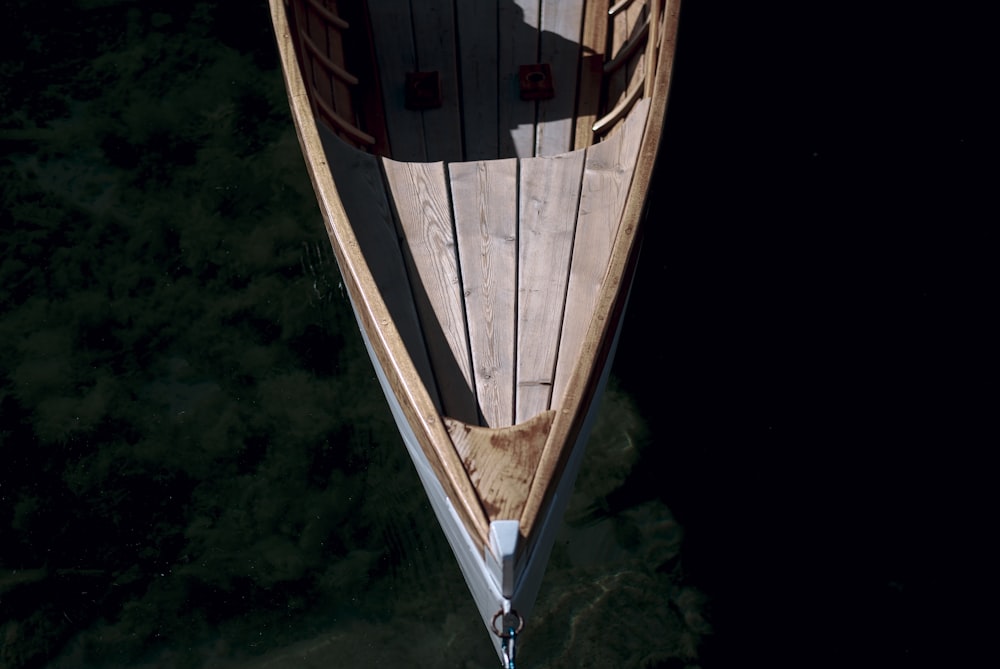 brown and white wooden boat on body of water during daytime