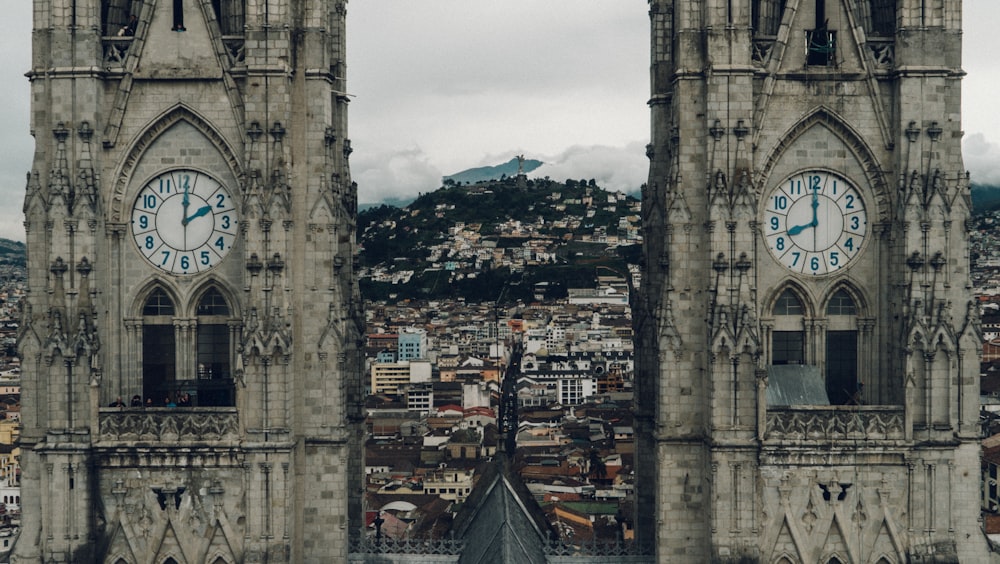 close-up photography of gray concrete clock towers