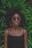 woman standing in front of green plant