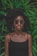 woman standing in front of green plant