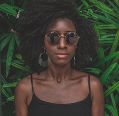 woman standing in front of green plant