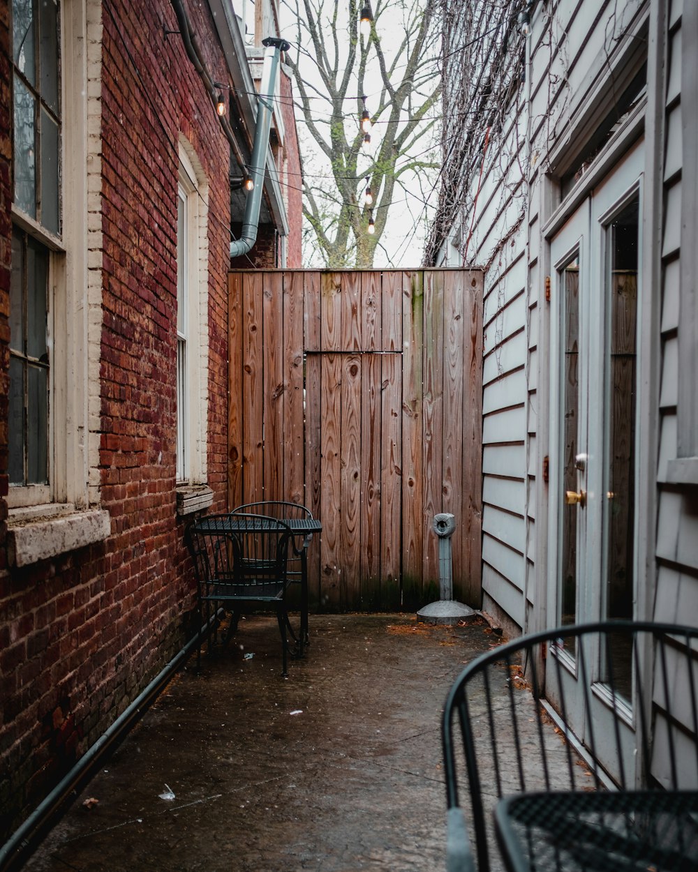 a wooden fence next to a brick building