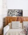 brown wooden sideboard beside beige fabric sofa