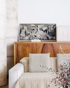 brown wooden sideboard beside beige fabric sofa