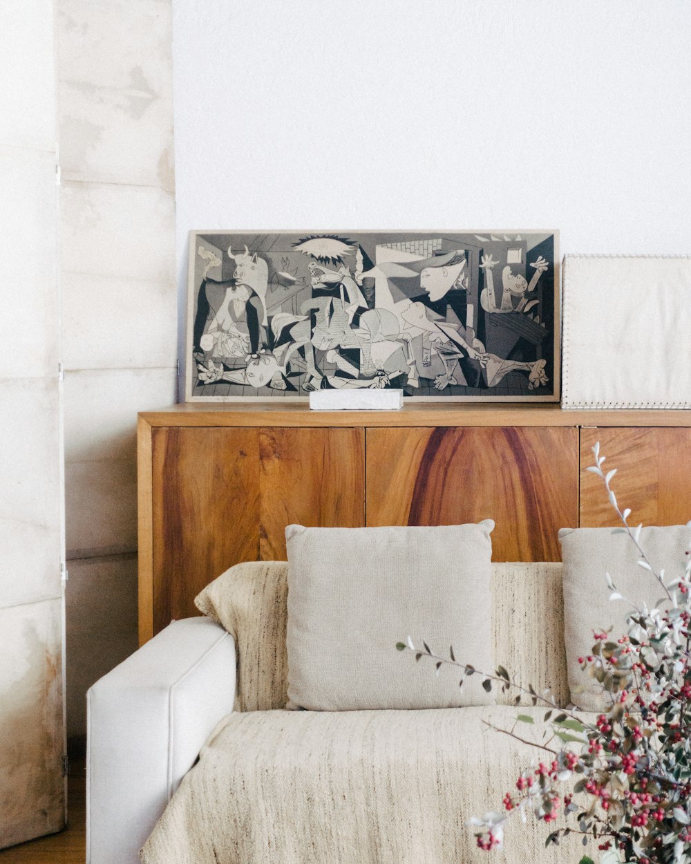 brown wooden sideboard beside beige fabric sofa