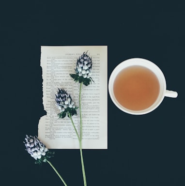 white ceramic tea cup beside white flowers