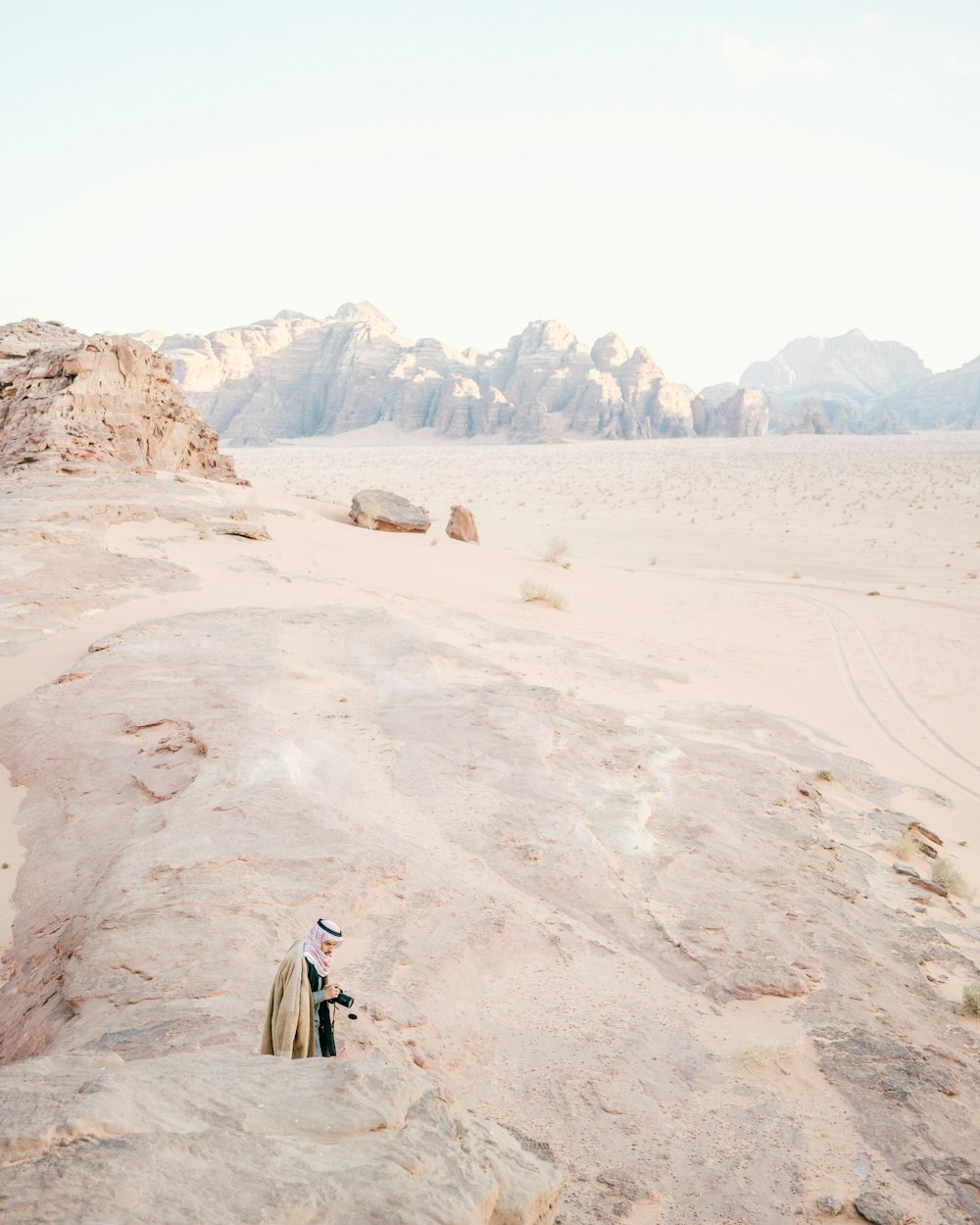 person standing on white sand desert