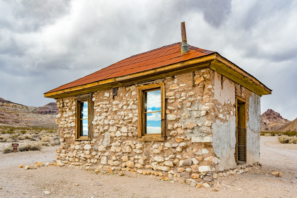 brown concrete house under white clouds