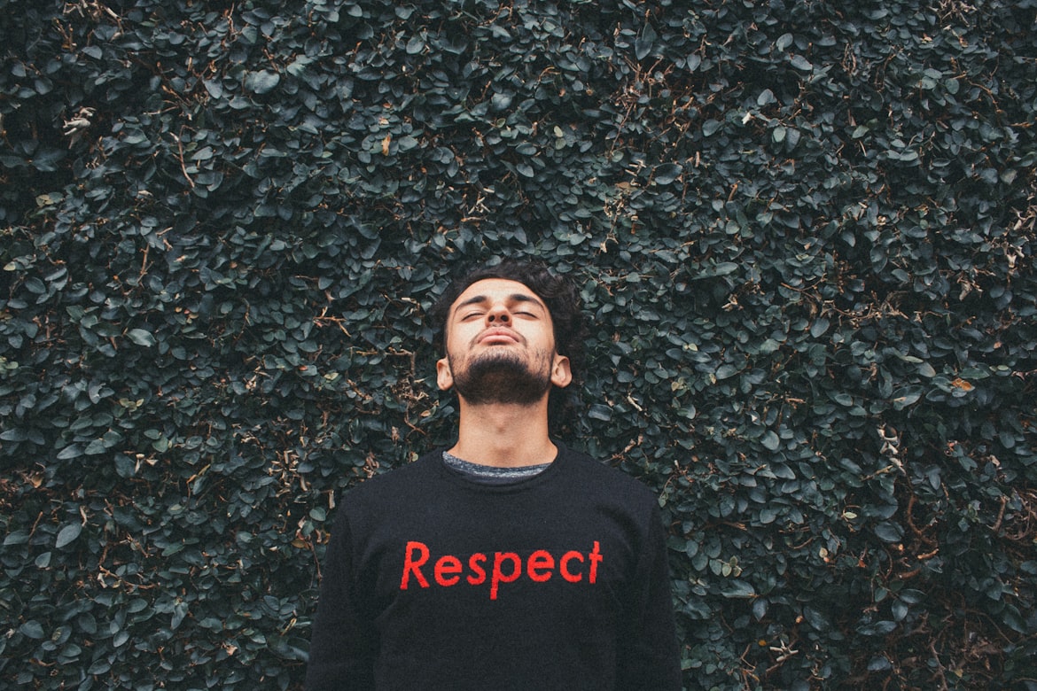 man wearing a respect sweater