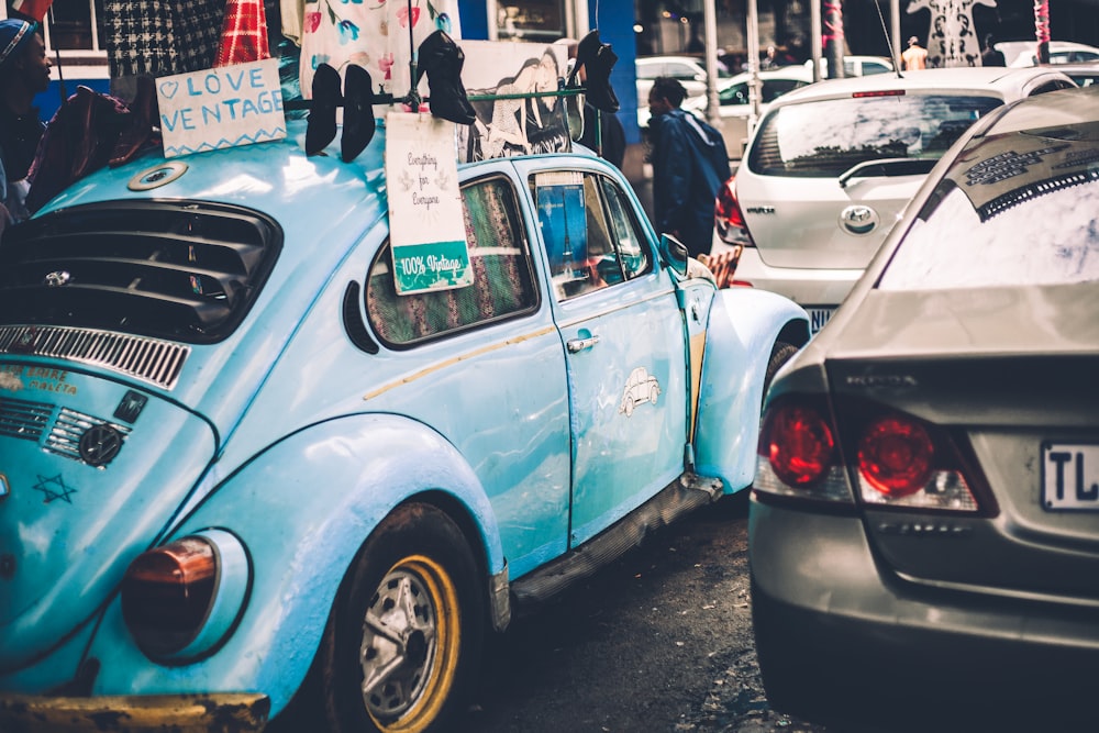 Love Ventage signage on top blue Volkswagen Beetle car