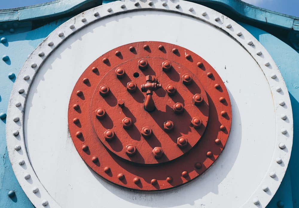 a close up of a red and white circular object