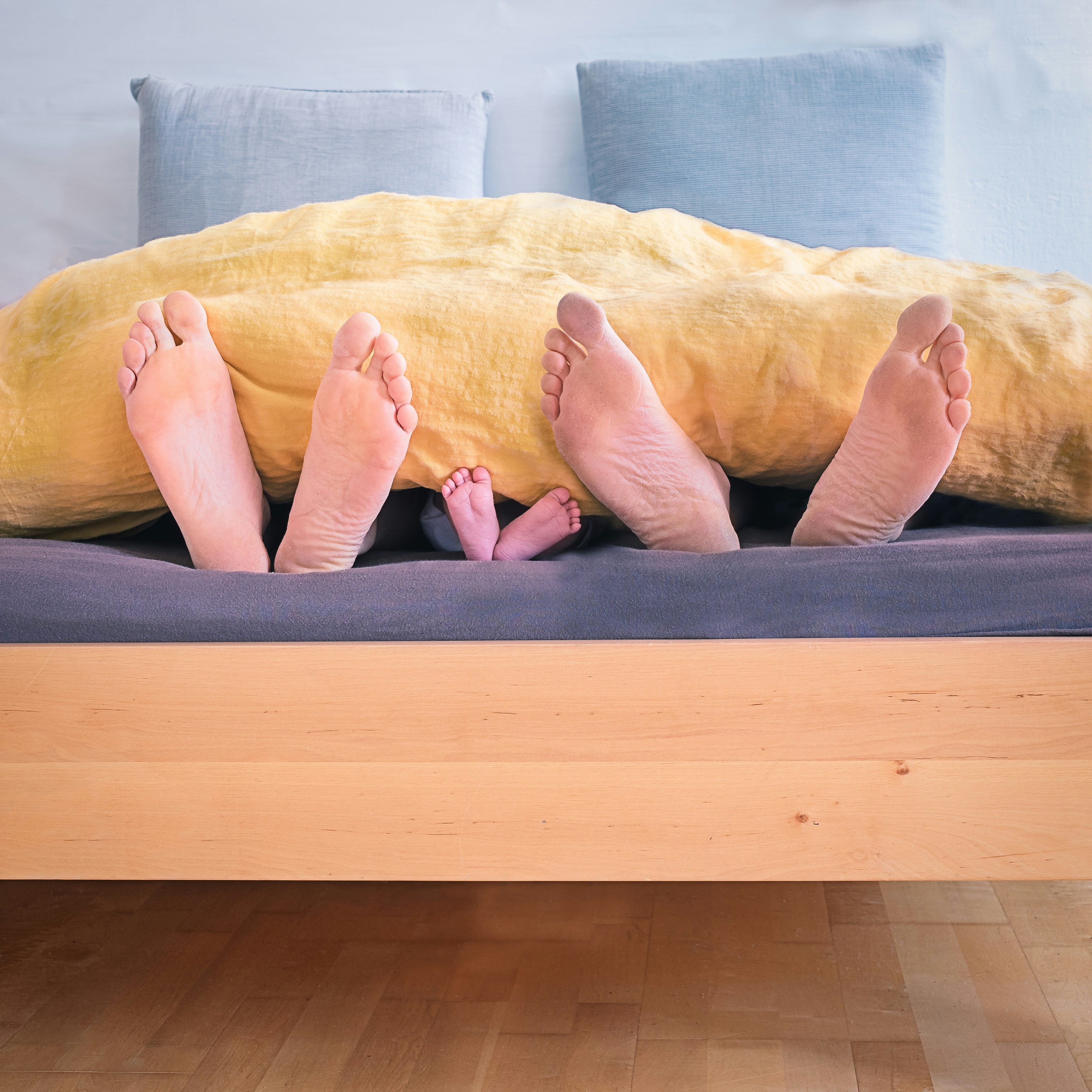 great photo recipe,how to photograph one
 and one —
 is three.; three people underneath yellow bed blanket