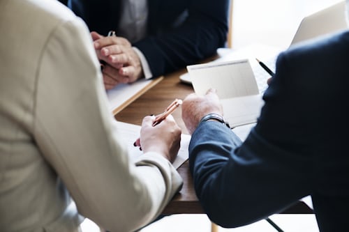 Three individuals having a meeting