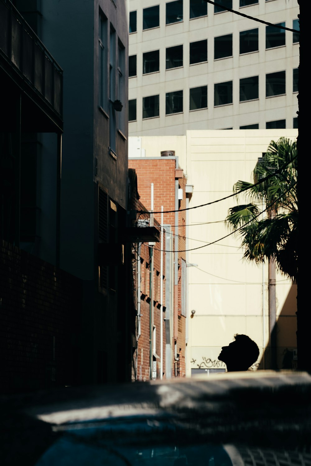 man looking up at building