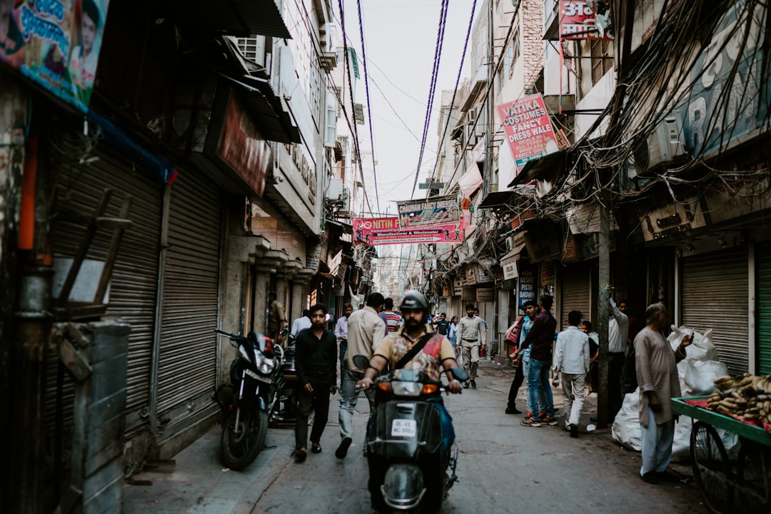 people in alley between buildings, Old Delhi Street Scene