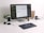 A modern workspace featuring a large monitor displaying a color palette application. Below the monitor, a keyboard and a graphics tablet with a stylus are present. A smartphone stands upright in a dock on the left next to a small potted plant. In the background, a wooden folder holder and a mug with text are visible. A stack of magazines or documents lies flat nearby.