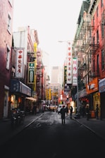 photography of people walking on street between buildings