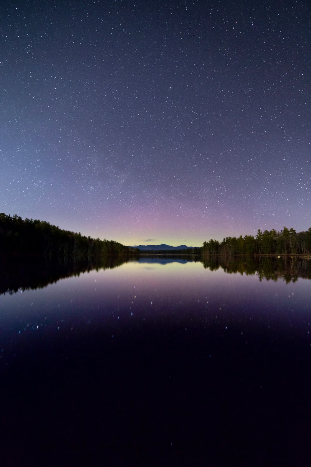 reflection photography of star and sky under calm body of water