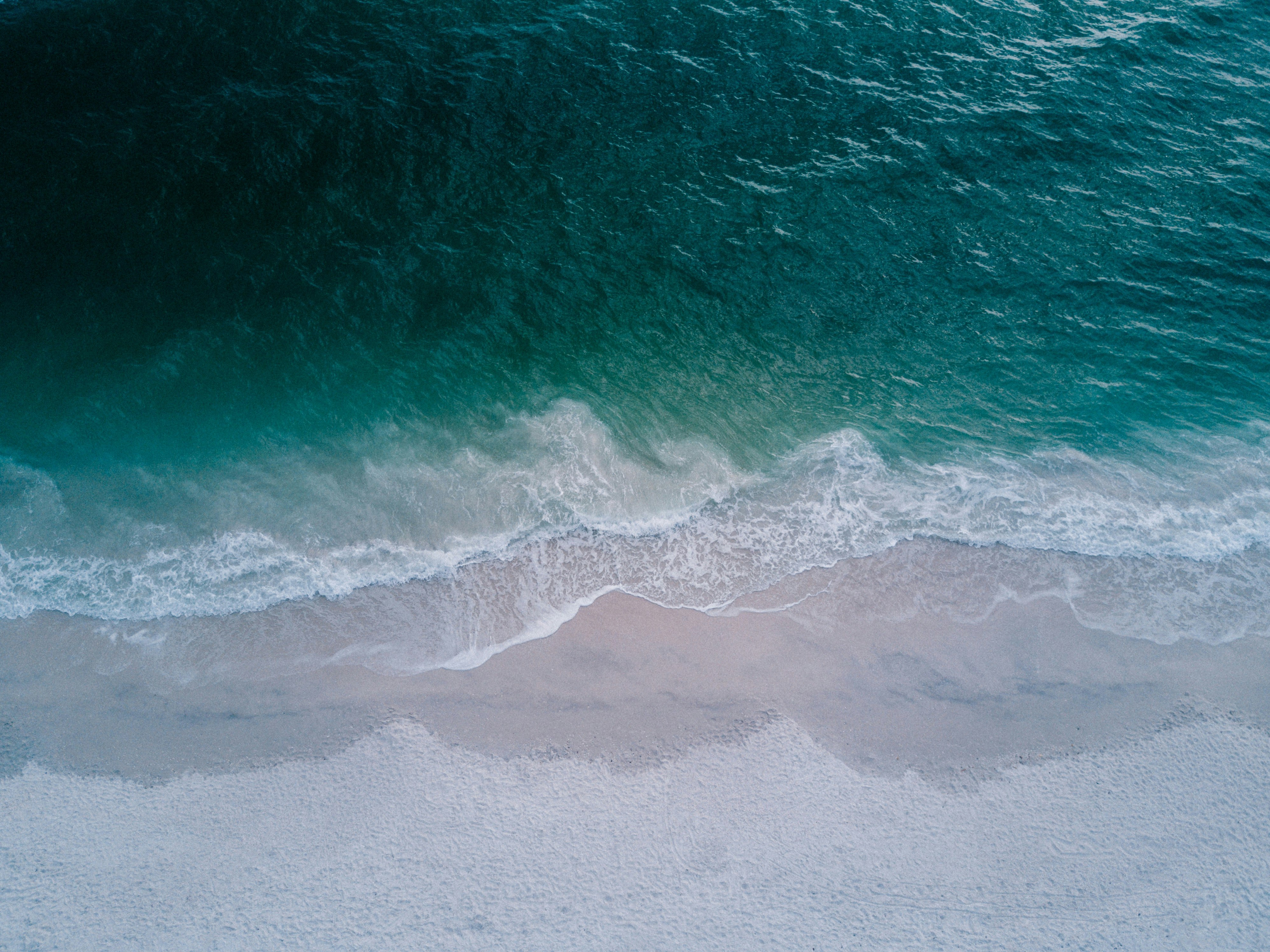 body of water beside sand