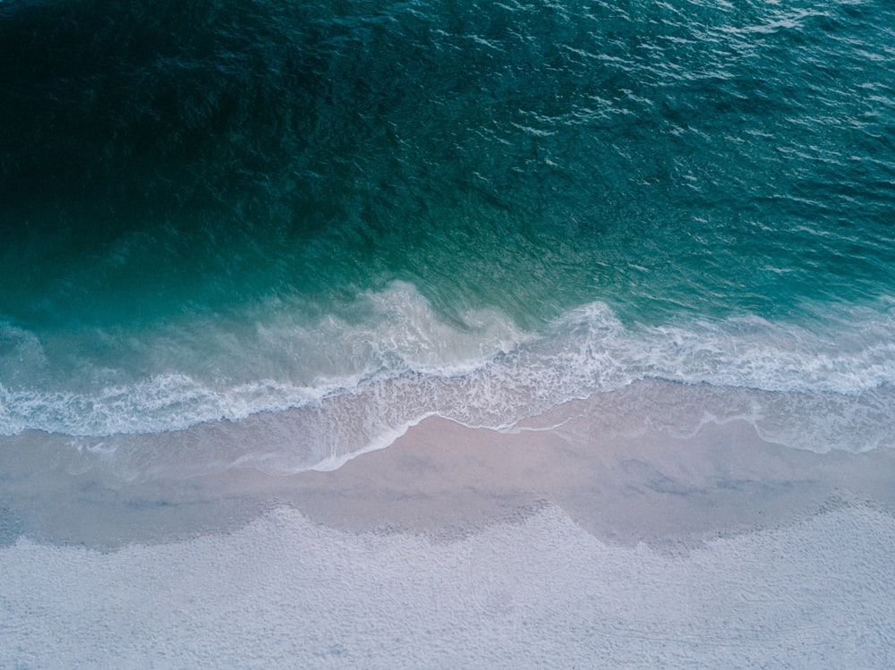 body of water beside sand