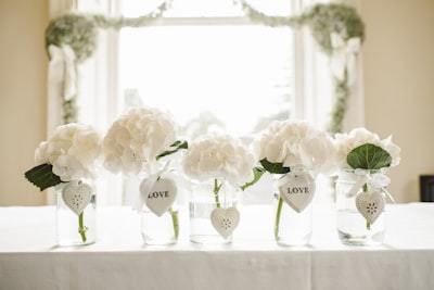 white flowers in glass jars fur google meet background