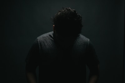 Close-up of a sensual, artistic silhouette against a moody backdrop.