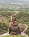 woman sitting on grey cliff