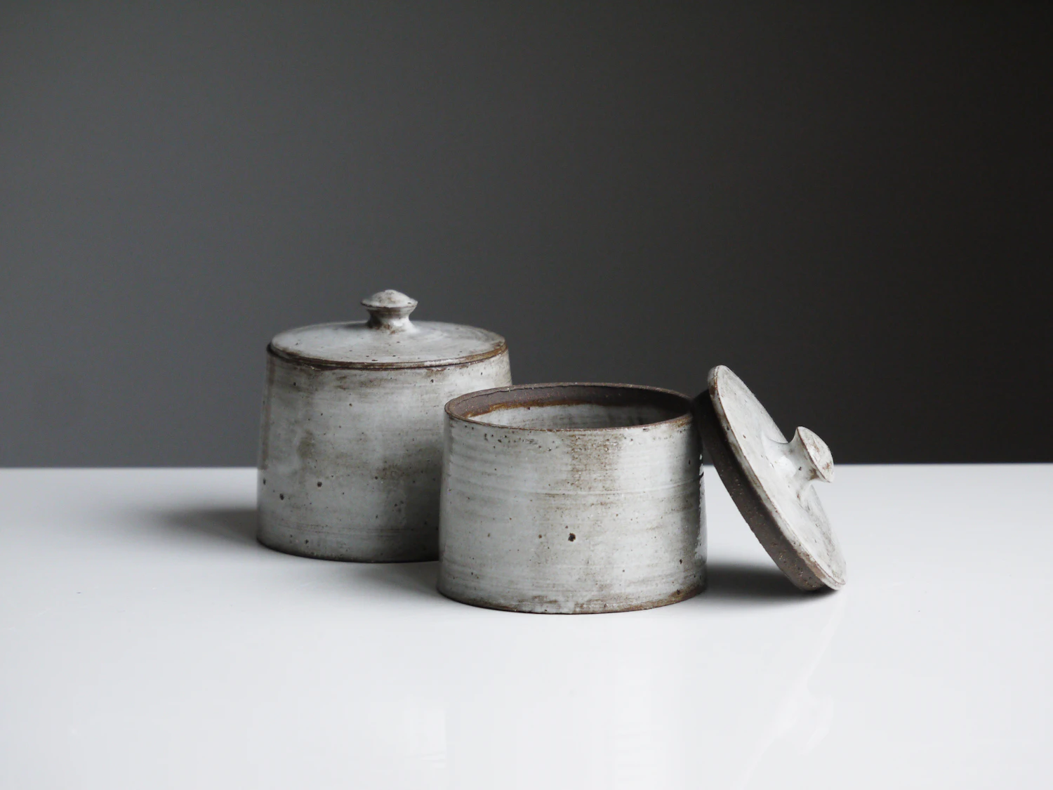 Tejado Clay — jars and bottles on a marble counter against green wall tile