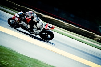racer riding on sports bike on race track