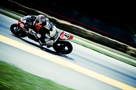 racer riding on sports bike on race track