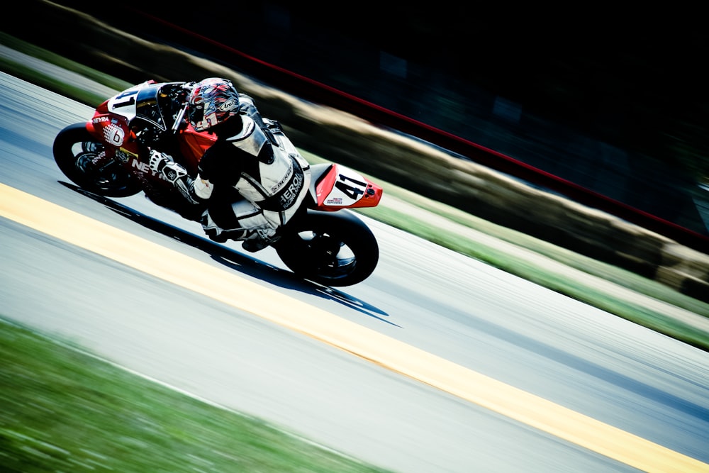 racer riding on sports bike on race track