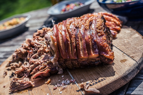 Grilled meat on brown chopping board