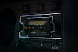 Close-up of an Icom radio device mounted on a vehicle dashboard.