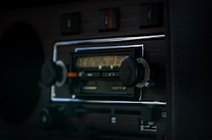 Close-up of a classic 1950s transistor radio with wooden casing and chrome details.