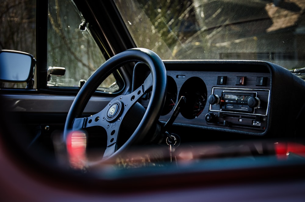 selective focus photography of vehicle steering