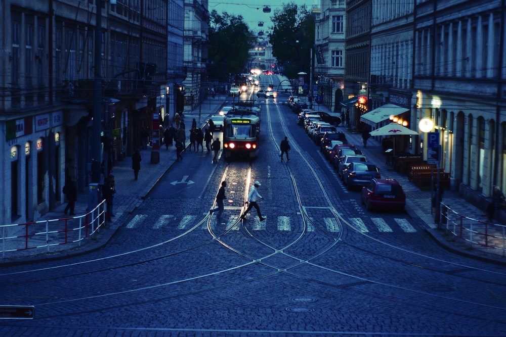 two person crossing street at pedestrian lane