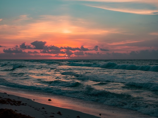 ocean waves under blue sky in Playa del Carmen Mexico