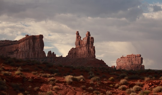 stone formation under nimbus clouds in Valley of the Gods United States