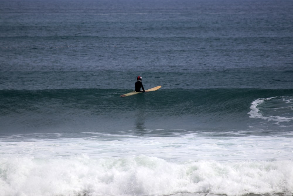 person surfing on waves during daytime