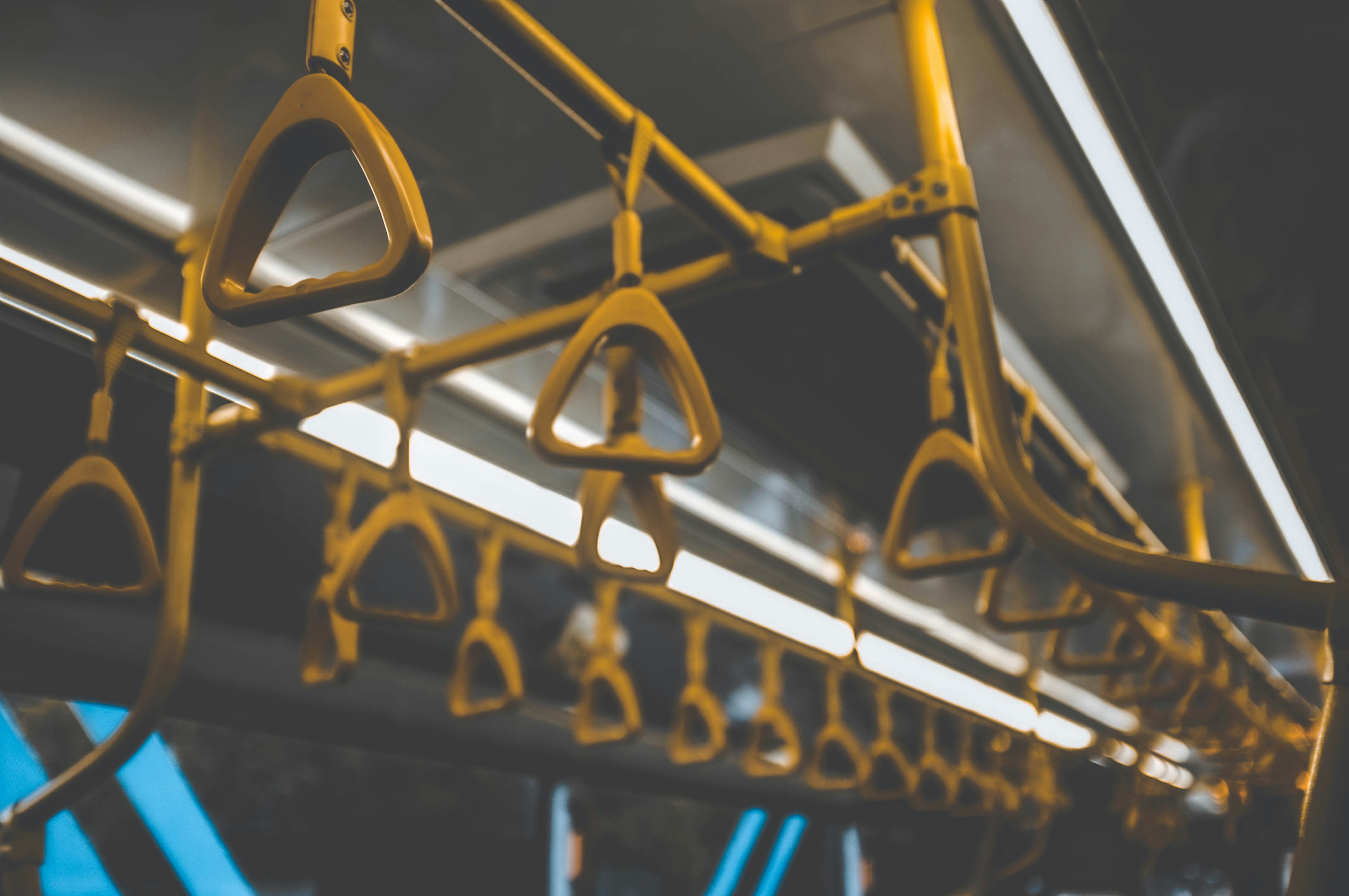 Empty yellow hand grips inside a public bus, symbolizing a lack of candidate engagement in employer branding.
